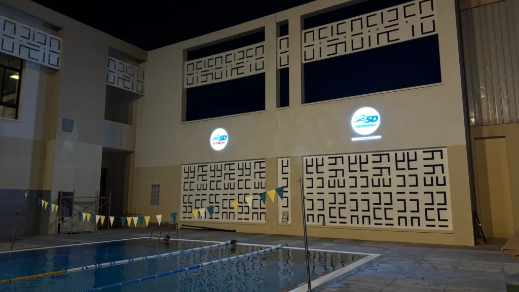 Outdoor swimming pool in Muscat for fitness and training at night.